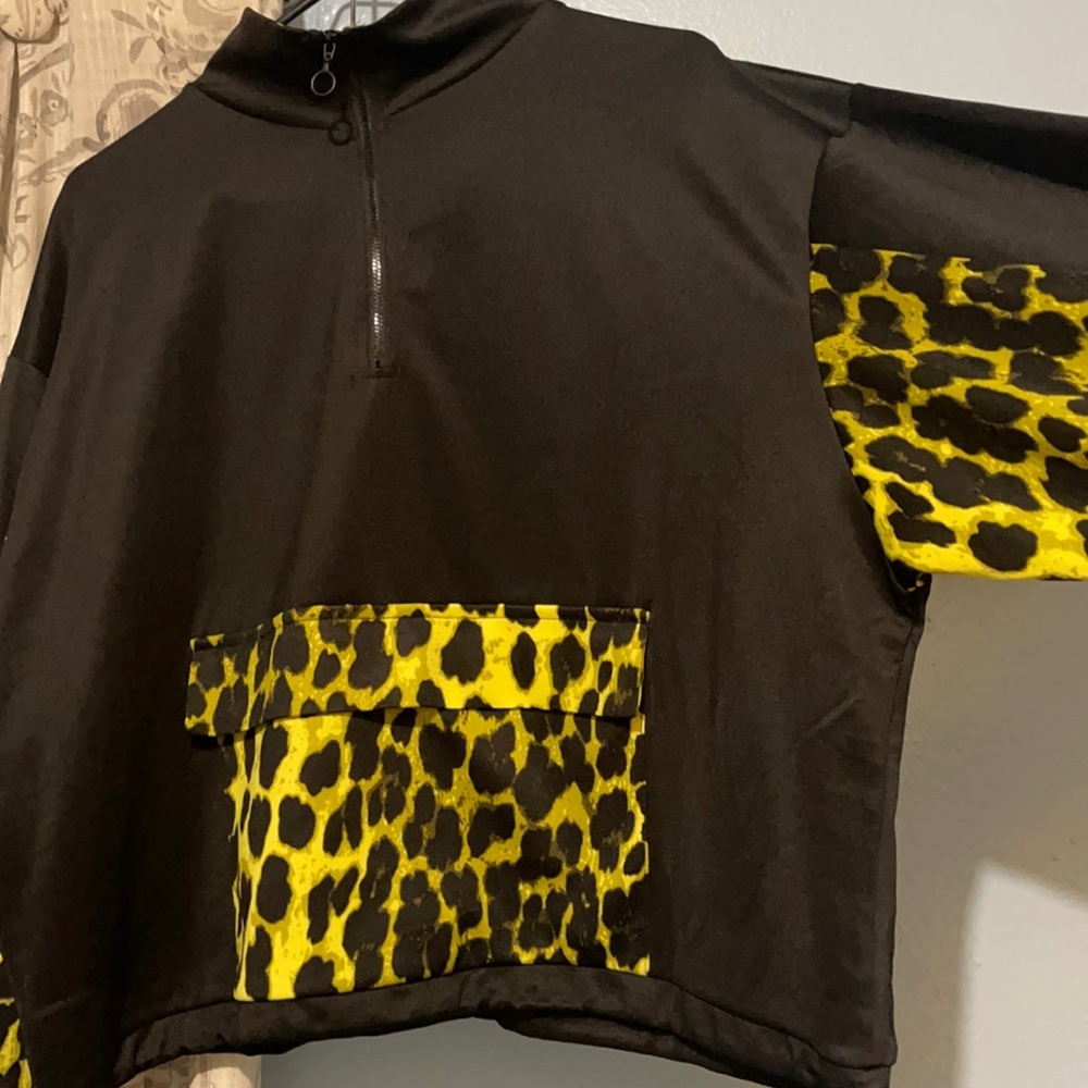Fashions a cropped sweater with storage pocket